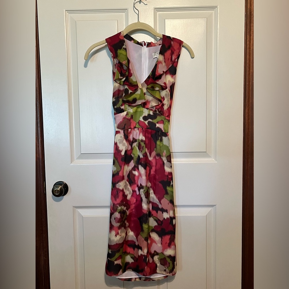 Elegant dress with waist accent, ties in the back to accentuate waist.